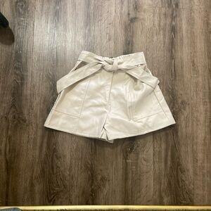Cream colored leather like shorts